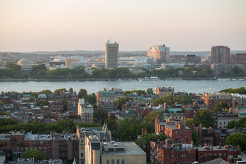 Cityscape with river and many buildings at autumn day.