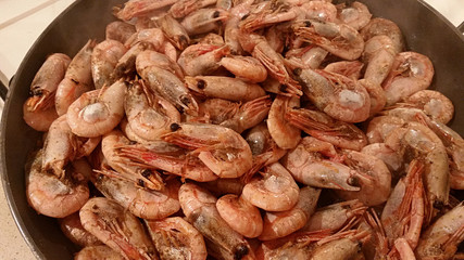 Delicious medium-sized shrimps with the heads fried on a pan