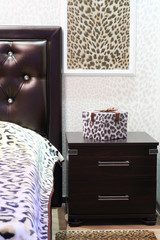 Gift box with a leopard pattern on night stand