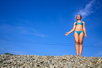 woman in a swimsuit on the railway embankment