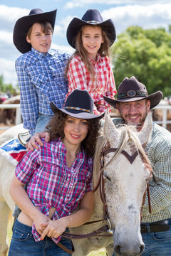 cowboy family of four with a horse closeup