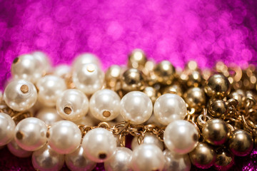 Jewelry background with close up of white and golden pearls