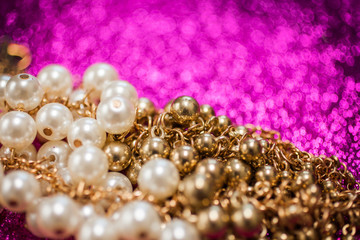 Jewelry background with white and golden pearls