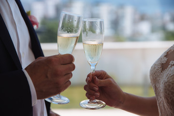 Two hands holding wineglases with champagne