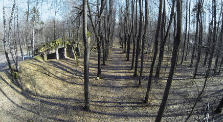 Old ashes near playground in forest at sunny spring day. Aerial view