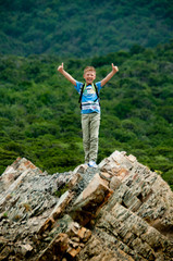 boy on a background of mountains