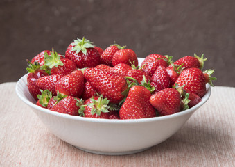 Fresh, red strawberries in plate.