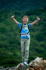 boy on a background of mountains