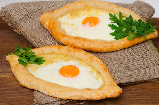 Side view of khachapuri with cheese and eggs on sacking