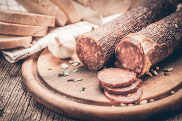 Sliced salami on cutting board