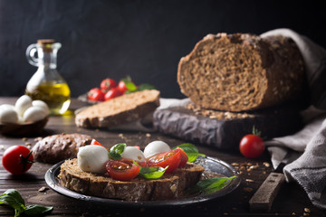 open sandwich with tomato, mozzarella and basil. Italian healthy food.