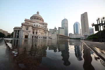 Complex of Christian Science Center with Mary Baker Eddy Library and Mother Church near pond at autumn morning.