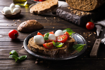open sandwich with tomato, mozzarella and basil. Italian healthy food.