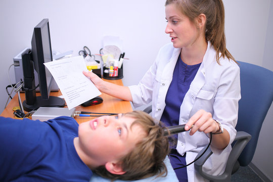 Doctor makes echoencephalography brain of boy