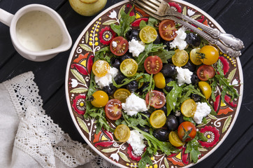 Arugula salad with cherry tomatoes feta and olives  