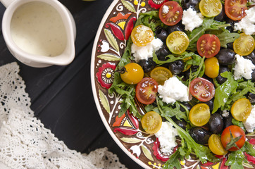 Arugula salad with cherry tomatoes feta and olives  