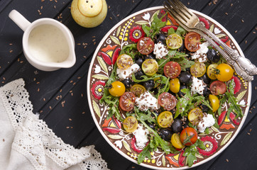 Arugula salad with cherry tomatoes feta and olives  