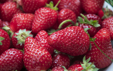 Fresh, red strawberries in plate close up photo.