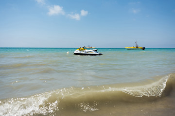 Sea waves with jet ski and motor boats