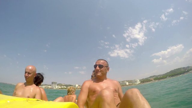 People having summer fun at pedal boat ride. front biew