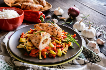 Baked chicken breast stuffed with Feta cheese, sun dried tomato and basil with steamed pepper, zucchini, tomato and stalk celery and rice