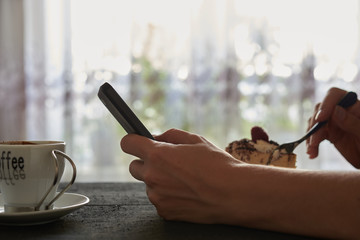 Naklejka na ściany i meble phone in hand and coffee