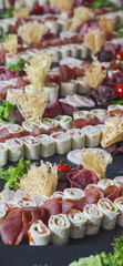 meat, fish, vegetable canapés on a festive wedding table outdoor