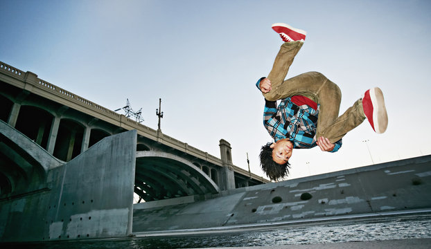 Asian Man Break Dancing Under Overpass