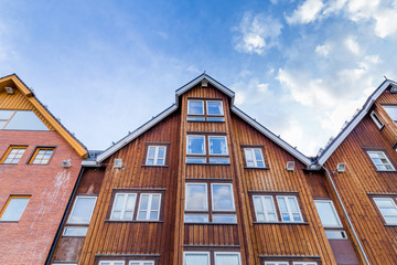 Old wooden warehouses along the harbor in the center of Tromso in northern Norway