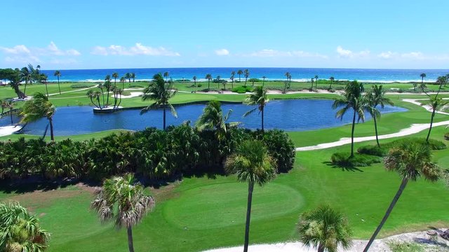 Aerial - Beautiful view of Golf Course next to ocean going up.