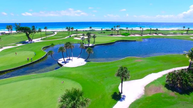 Aerial - Beautiful view of Golf Course next to ocean with movement.