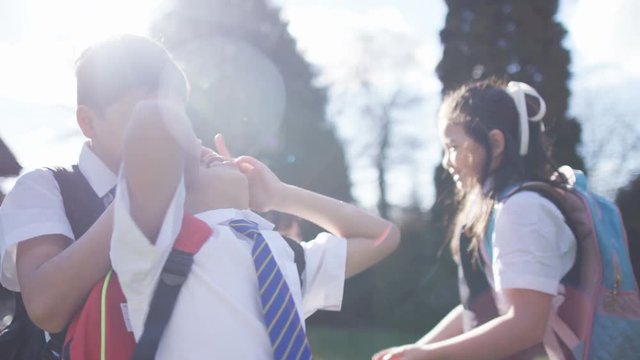  Happy young children playing outdoors in school playground