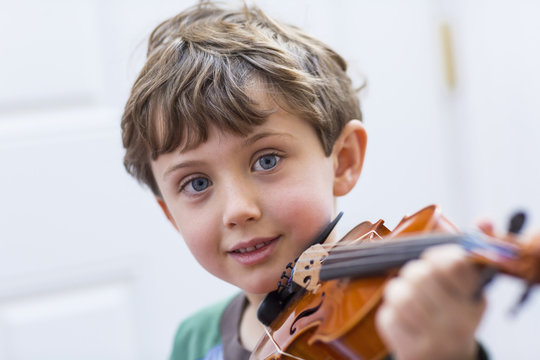 Close up of boy holding violin