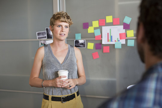 Businesswoman talking to colleague in office