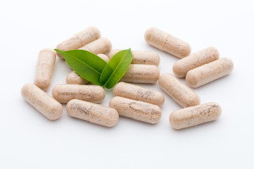 Ginkgo biloba capsule on the white background.