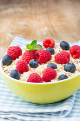 Oatmeal porridge with berries. Raspberries and blueberries.