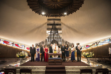 Family posing at wedding in church