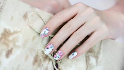 Nail design . Manicure nail paint . beautiful female hand with colorful nail art design manicure