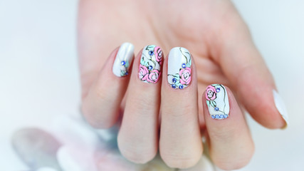 Nail design . Manicure nail paint . beautiful female hand with colorful nail art design manicure