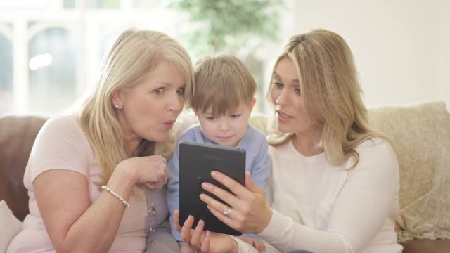  3 Generations of happy family taking selfie with tablet computer