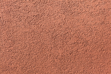 Terracotta painted stucco wall. Background texture