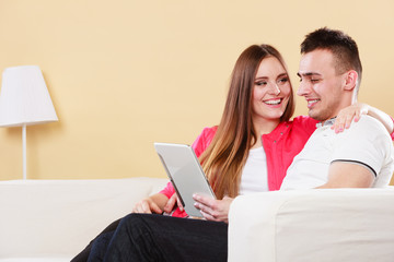 Fototapeta premium couple with tablet sitting on couch at home