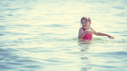 Little girl kid in sea water. Fun