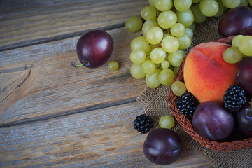 Mix of fresh berries and fruits on rustic wooden background