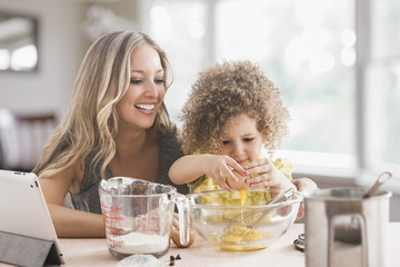 Mother and daughter baking together