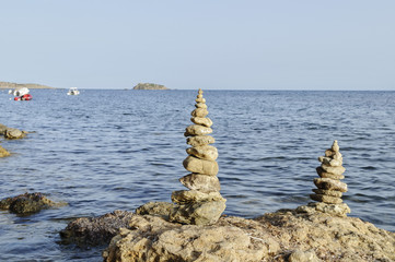 Fototapeta na wymiar Stone tower on the horizon Ibiza, Spain, the island
