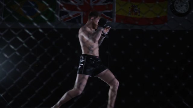  Muscular MMA fighter training alone in dark environment