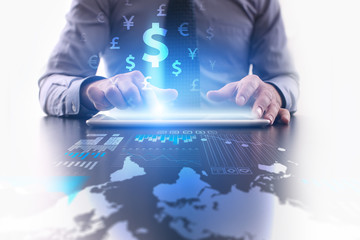 Naklejka premium Businessman pressing on the tablet pc screen with graphs and dollar icons. Trading and investment concept. 