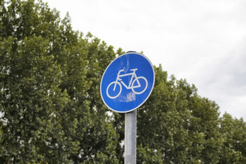 Bicycle traffic sign in BerlinBicycle traffic sign with background of trees in Berlin