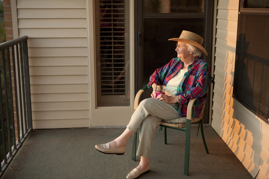 Older Caucasian woman sitting on porch